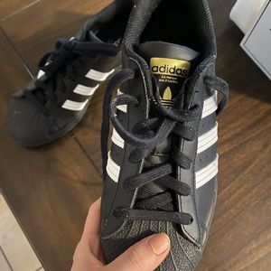 Adidas black and gold Superstar.